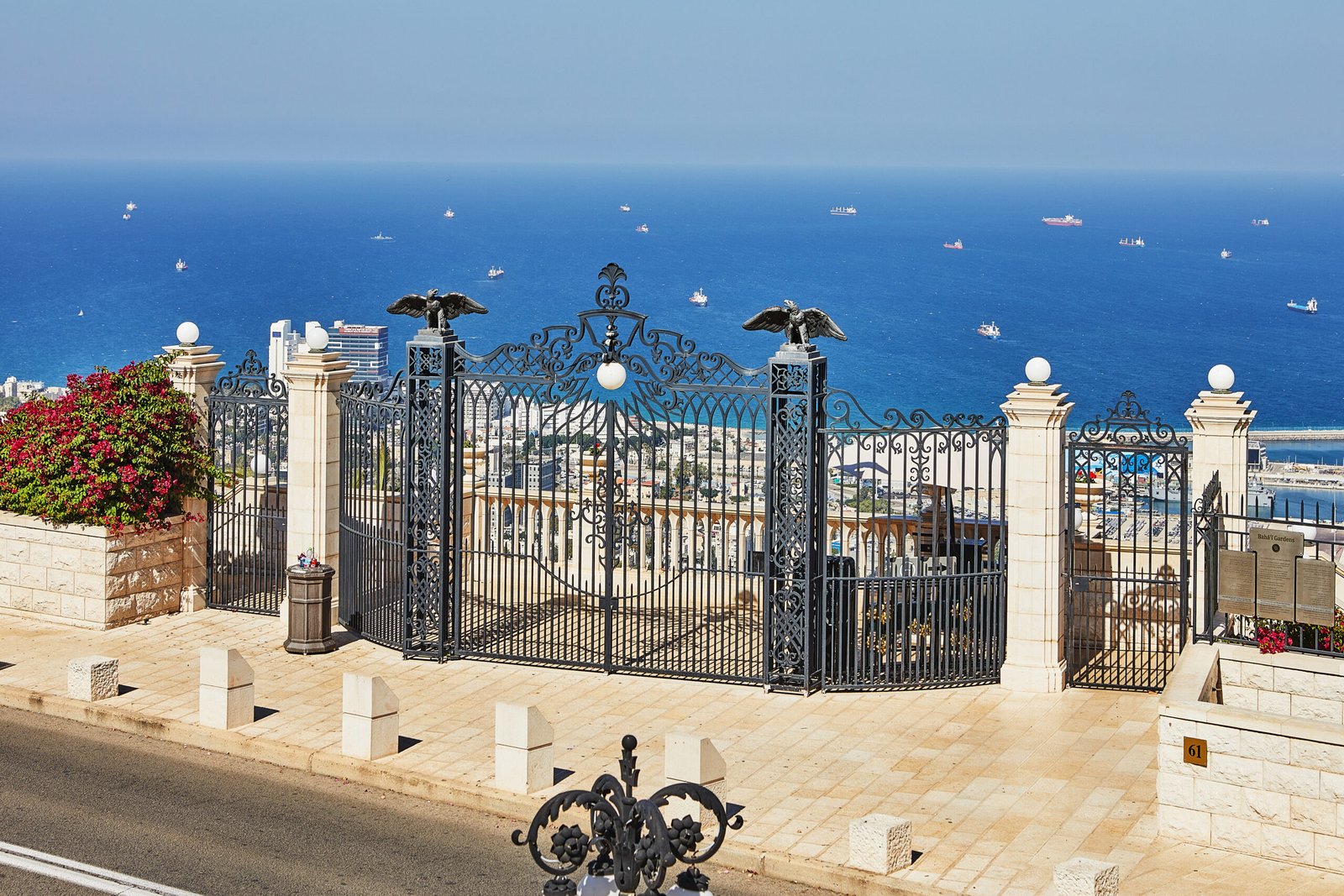 Panorama of the Bahai Gardens with the seaport in the background and blue sky with clouds.